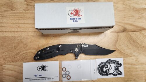 Preowned NEW Hinderer XM-18 3.5″ Bowie Frame Lock Folding Knife, Battle Black MagnaCut Bowie Blade & Battle Black Titanium with G-10 Handle
